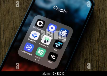 Assorted crypto apps are seen on an iPhone - Coinbase Pro, Coinbase Wallet, Crypto.com, Blockchain, Bitcoin.com, FTX, CoinMarketCap, KuCoin, Strike. Stock Photo