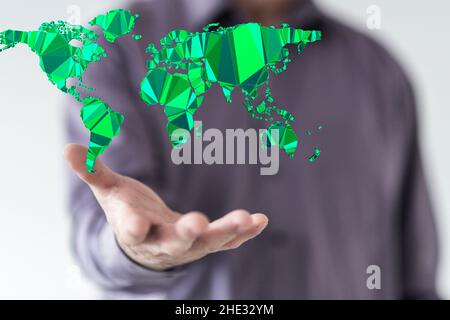 Businessman holding a digital render of a green world map- environment concept Stock Photo