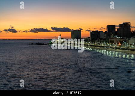 Sunset over Barra beach and the iconic Barra lighthouse in Salvador, Bahia, Brazil. Stock Photo