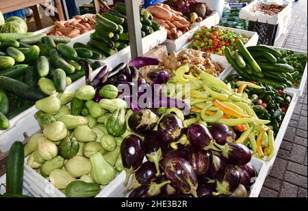 Fresh produce including peppers, cucumbers, Chayote (Sechium edule),and eggplants at the market in Belize City, Belize Stock Photo