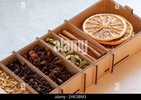 set of spices for mulled wine in a wooden box close-up Stock Photo