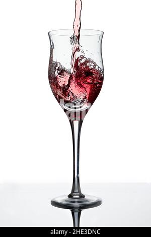 Serving a beautiful glass with red wine. White background, Glass cup. Elegance, good taste, style concept. Stock Photo