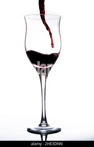 Serving a beautiful glass with red wine. White background, Glass cup. Elegance, good taste, style concept. Stock Photo