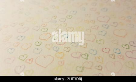 many hearts drawn with colored pencils on white paper. Stock Photo