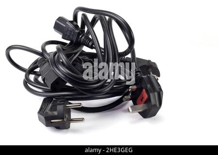 Power cables. Pile of computers electric cables with plug isolated on white background. Stock Photo