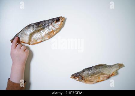 Dried fish on a white background, top view, copy space. Stock Photo