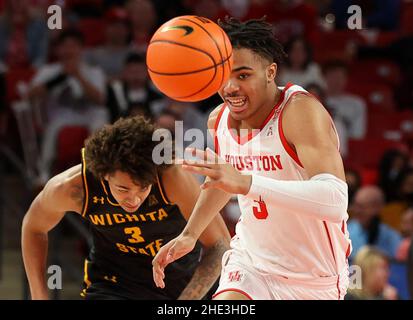 Houston guard Ramon Walker Jr. holds his knee after falling during the ...