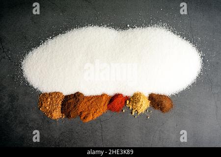 Ham Glaze Ingredients on a Dark Background: Sugar and spices used to make a ham glaze on a dark stone background Stock Photo