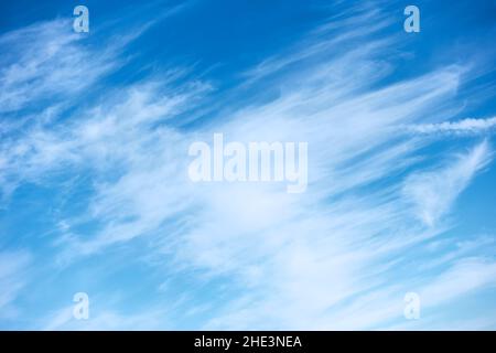 Fast moving clouds in the blue sky Stock Photo