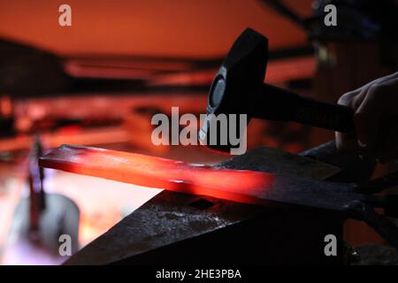 Smiting with local iron steel Blacksmith creating Hammer furnace creating knife sword Stock Photo