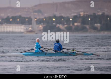 Egyptian women training in a double scull practicing rowing on the Nile River in Aswan, Egypt. Stock Photo