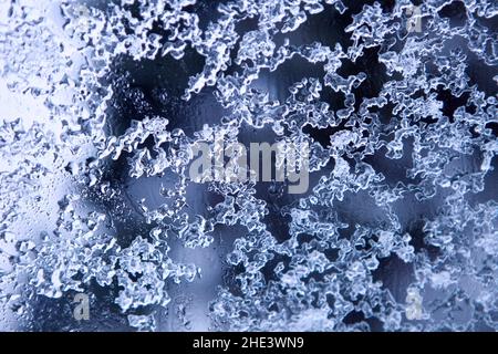 Frozen decorative water drops - natural winter ice pattern on glass. melting snowflakes Stock Photo