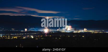 A panorama of fireworks on New Year's Eve. Stunning night city urban shot. . High quality photo Stock Photo