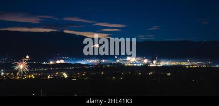 A panorama of fireworks on New Year's Eve. Stunning night city urban shot. . High quality photo Stock Photo