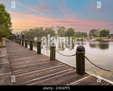 Port at dusk, water, boats, and walking path. The port of Sale, a town in the state of Victoria, Australia. Stock Photo