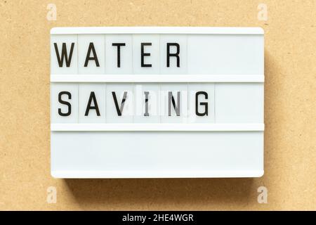 Lightbox with word water saving on wood background Stock Photo