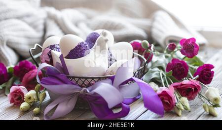 Easter composition with eggs, decorated with purple sparkles. Stock Photo