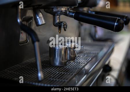 Close up of the process of making espresso in a professional coffee machine. Stock Photo
