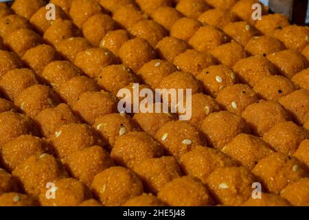 Indian sweet motichoor laddoo or Bundi laddu made of flour very small balls or boondis which are deep fried and soaked in sugar syrup before making ba Stock Photo