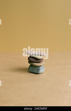 Stack of pebble stones on brown table background Stock Photo