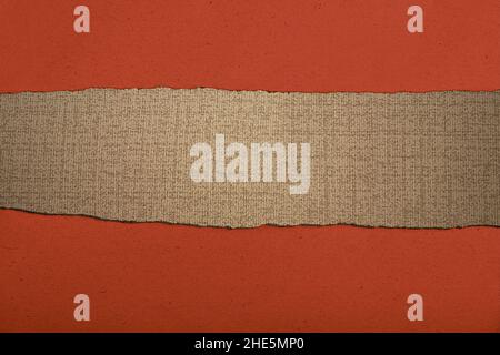 Paper with a hole torn in the middle with red background Stock Photo