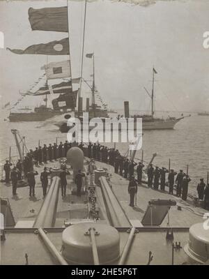 Sailors on ship deck salute at ship passing by Stock Photo