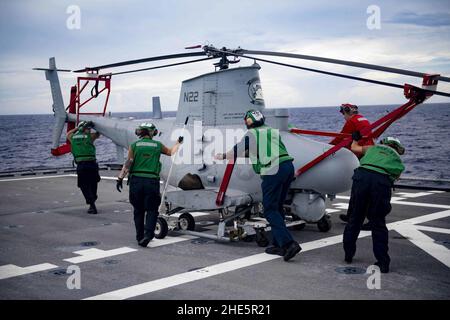 Sailors push an MQ-8B Fire Scout on the flight deck of USS Gabrielle Giffords (LCS 10). (48793085853). Stock Photo