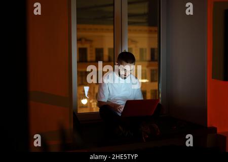Workaholic specialist work overtime. Programmer on remote outsource occupation. Nighttime lifestyle Stock Photo