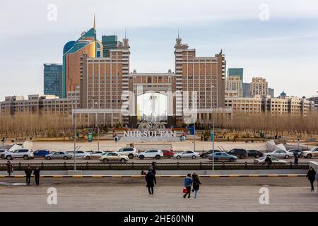 Nur Sultan (Astana), Kazakhstan, 11.11.21. Landscape of Nur Sultan City with monumental Gate with skyscrapers, Bayterek Tower and Nur Sultan logo sign Stock Photo