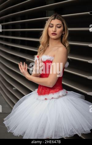 Ballerina wearing high heels and christmas dress posing outdoors Stock Photo