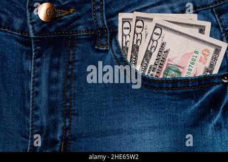 Banknotes, money in a jeans pocket, close up. Money stick out of the jeans pocket, finance and currency concept. Concept of rich people, saving or spe Stock Photo