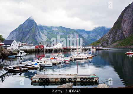 Typical Rourbuer fishing cabins in Lofoten Nusfjord village on a rainy day, summertime. Traditional norwegian red wooden houses Stock Photo