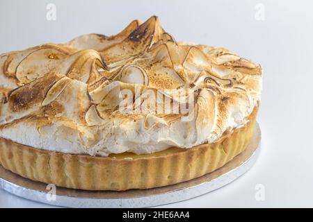 Lemon meringue pie on silver cake server isolated on white background Stock Photo