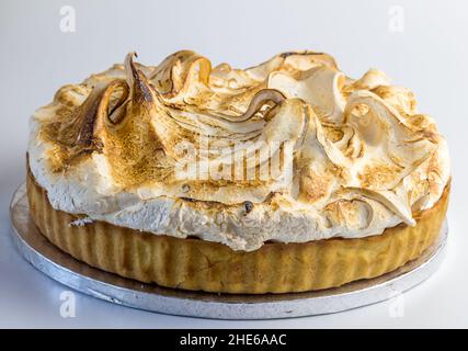 Lemon meringue pie on silver cake server isolated on white Stock Photo