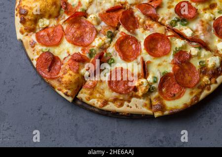 Salami and chili pizza on grey background - Pepperoni pizza background Stock Photo