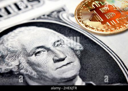 Cryptocurrency coin on top of a US dollar bill Stock Photo