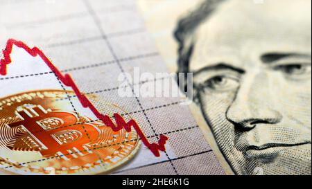 Cryptocurrency coin on top of a US dollar bill Stock Photo