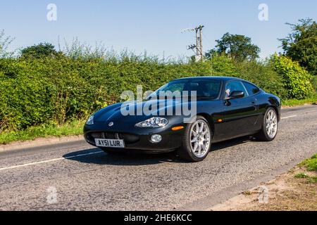 2001 black Jaguar XKR 3996cc automatic, 5.0 V8 supercharged 2dr auto coupe en-route to Capesthorne Hall classic July car show, Cheshire, UK Stock Photo