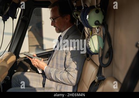 Serious focused man reading text message on smartphone Stock Photo