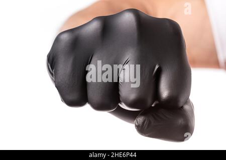 Fist punch in black rubber glove isolated on white background. Clenched fist as a symbol of threat, close up Stock Photo