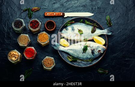 Fresh fish, dorado and spices. Raw dorado, or sea carp. Stock Photo