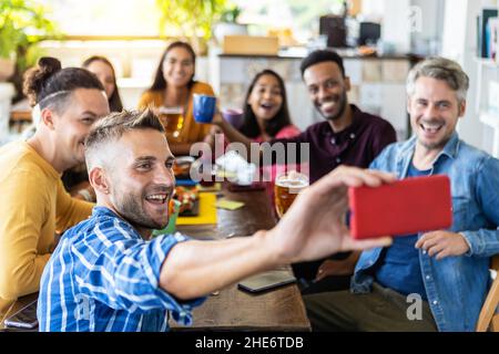 Multiracial young people taking selfie group portrait while having breakfast Stock Photo