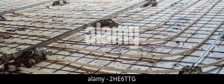 Pipe fitter mounted underfloor heating. Heating system and underfloor heating BANNER, LONG FORMAT Stock Photo