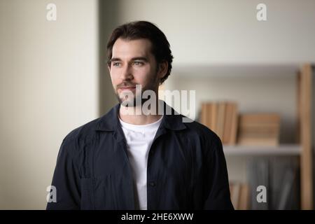 Happy dreamy young man looking in distance. Stock Photo
