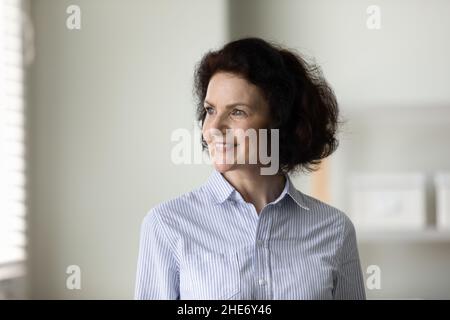 Happy dreamy old woman looking in distance. Stock Photo
