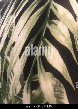 Tropical Palm Leaf Pattern On Black Fabric Texture Stock Photo