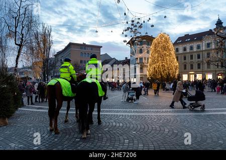 Policemen on horses on Preseren square, decorated for Christmas and New Years celebration Stock Photo