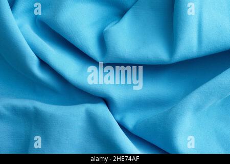 Light blue crumpled fabric texture background. Close up. Stock Photo