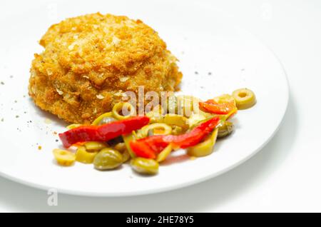 Cod and prawns red Thai style fish cake served with pickled olives, gherkin, garlic, and red peppers, Asian food Stock Photo
