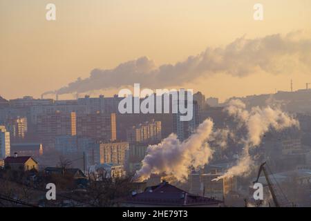 Urban landscape with smoke from heating systems. Vladivostok, Russia Stock Photo